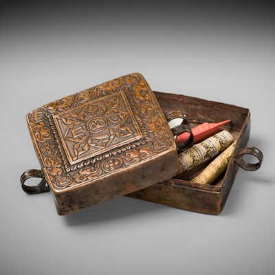 Lot 48 - A COPPER REPOUSSÉ AMULET BOX AND COVER, GAU, WITH SUTRA ROLLS AND RITUAL OBJECTS, 18TH-19TH CENTURY