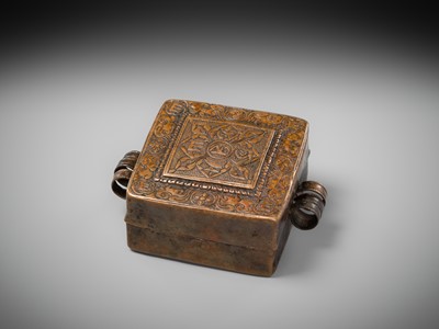 Lot 48 - A COPPER REPOUSSÉ AMULET BOX AND COVER, GAU, WITH SUTRA ROLLS AND RITUAL OBJECTS, 18TH-19TH CENTURY