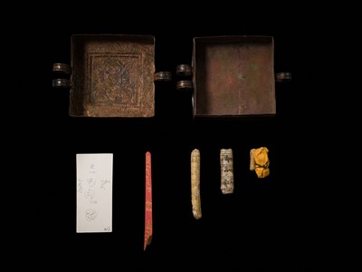 Lot 48 - A COPPER REPOUSSÉ AMULET BOX AND COVER, GAU, WITH SUTRA ROLLS AND RITUAL OBJECTS, 18TH-19TH CENTURY