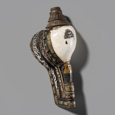 Lot 11 - A CARVED CONCH SHELL TRUMPET (DUNG DKAR) WITH COPPER, SILVER AND BRONZE REPOUSSÉ MOUNTS AND GEMSTONE INLAYS