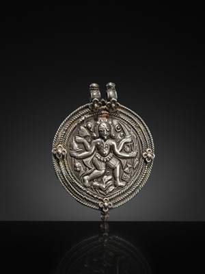 Lot 108 - A SILVER REPOUSSÉ AMULET IN THE SHAPE OF A PIPAL LEAF DEPICTING THE DANCING SHIVA BHAIRAVA, AJMER, 19TH CENTURY
