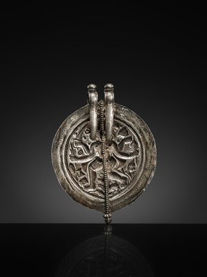Lot 108 - A SILVER REPOUSSÉ AMULET IN THE SHAPE OF A PIPAL LEAF DEPICTING THE DANCING SHIVA BHAIRAVA, AJMER, 19TH CENTURY