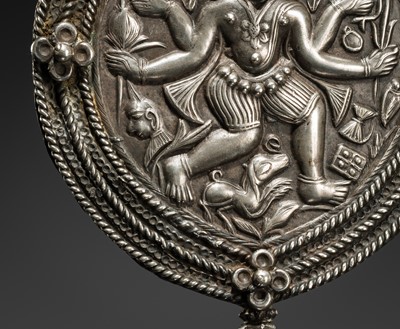 Lot 108 - A SILVER REPOUSSÉ AMULET IN THE SHAPE OF A PIPAL LEAF DEPICTING THE DANCING SHIVA BHAIRAVA, AJMER, 19TH CENTURY