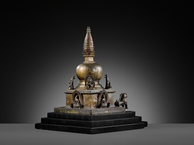 Lot 112 - AN IMPORTANT INSCRIBED BRONZE STUPA WITH FIVE DIRECTIONAL BUDDHAS, FOUR TARAS, GUARDIAN LIONS AND SNAKE CANOPY, 17TH-18TH CENTURY