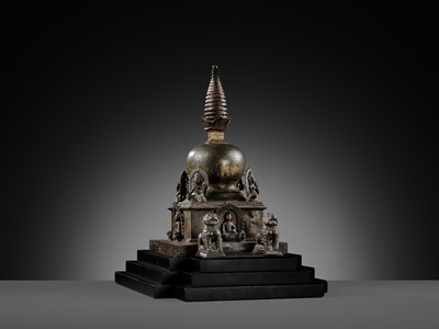 Lot 112 - AN IMPORTANT INSCRIBED BRONZE STUPA WITH FIVE DIRECTIONAL BUDDHAS, FOUR TARAS, GUARDIAN LIONS AND SNAKE CANOPY, 17TH-18TH CENTURY