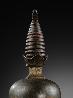 Lot 112 - AN IMPORTANT INSCRIBED BRONZE STUPA WITH FIVE DIRECTIONAL BUDDHAS, FOUR TARAS, GUARDIAN LIONS AND SNAKE CANOPY, 17TH-18TH CENTURY