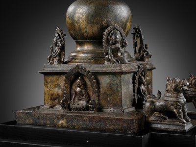 Lot 112 - AN IMPORTANT INSCRIBED BRONZE STUPA WITH FIVE DIRECTIONAL BUDDHAS, FOUR TARAS, GUARDIAN LIONS AND SNAKE CANOPY, 17TH-18TH CENTURY