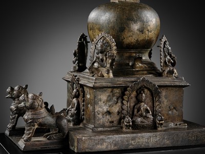 Lot 112 - AN IMPORTANT INSCRIBED BRONZE STUPA WITH FIVE DIRECTIONAL BUDDHAS, FOUR TARAS, GUARDIAN LIONS AND SNAKE CANOPY, 17TH-18TH CENTURY