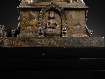 Lot 112 - AN IMPORTANT INSCRIBED BRONZE STUPA WITH FIVE DIRECTIONAL BUDDHAS, FOUR TARAS, GUARDIAN LIONS AND SNAKE CANOPY, 17TH-18TH CENTURY