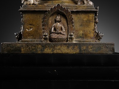 Lot 112 - AN IMPORTANT INSCRIBED BRONZE STUPA WITH FIVE DIRECTIONAL BUDDHAS, FOUR TARAS, GUARDIAN LIONS AND SNAKE CANOPY, 17TH-18TH CENTURY