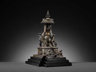 Lot 112 - AN IMPORTANT INSCRIBED BRONZE STUPA WITH FIVE DIRECTIONAL BUDDHAS, FOUR TARAS, GUARDIAN LIONS AND SNAKE CANOPY, 17TH-18TH CENTURY