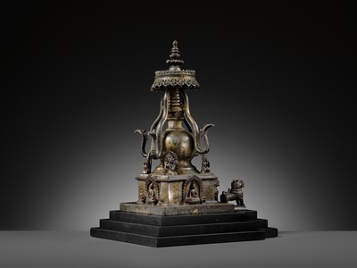 Lot 112 - AN IMPORTANT INSCRIBED BRONZE STUPA WITH FIVE DIRECTIONAL BUDDHAS, FOUR TARAS, GUARDIAN LIONS AND SNAKE CANOPY, 17TH-18TH CENTURY