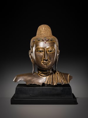 Lot 21 - A RARE AND LARGE GILT-LACQUERED BRONZE BUST OF BUDDHA, EARLY MANDALAY PERIOD