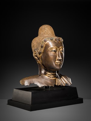 Lot 21 - A RARE AND LARGE GILT-LACQUERED BRONZE BUST OF BUDDHA, EARLY MANDALAY PERIOD