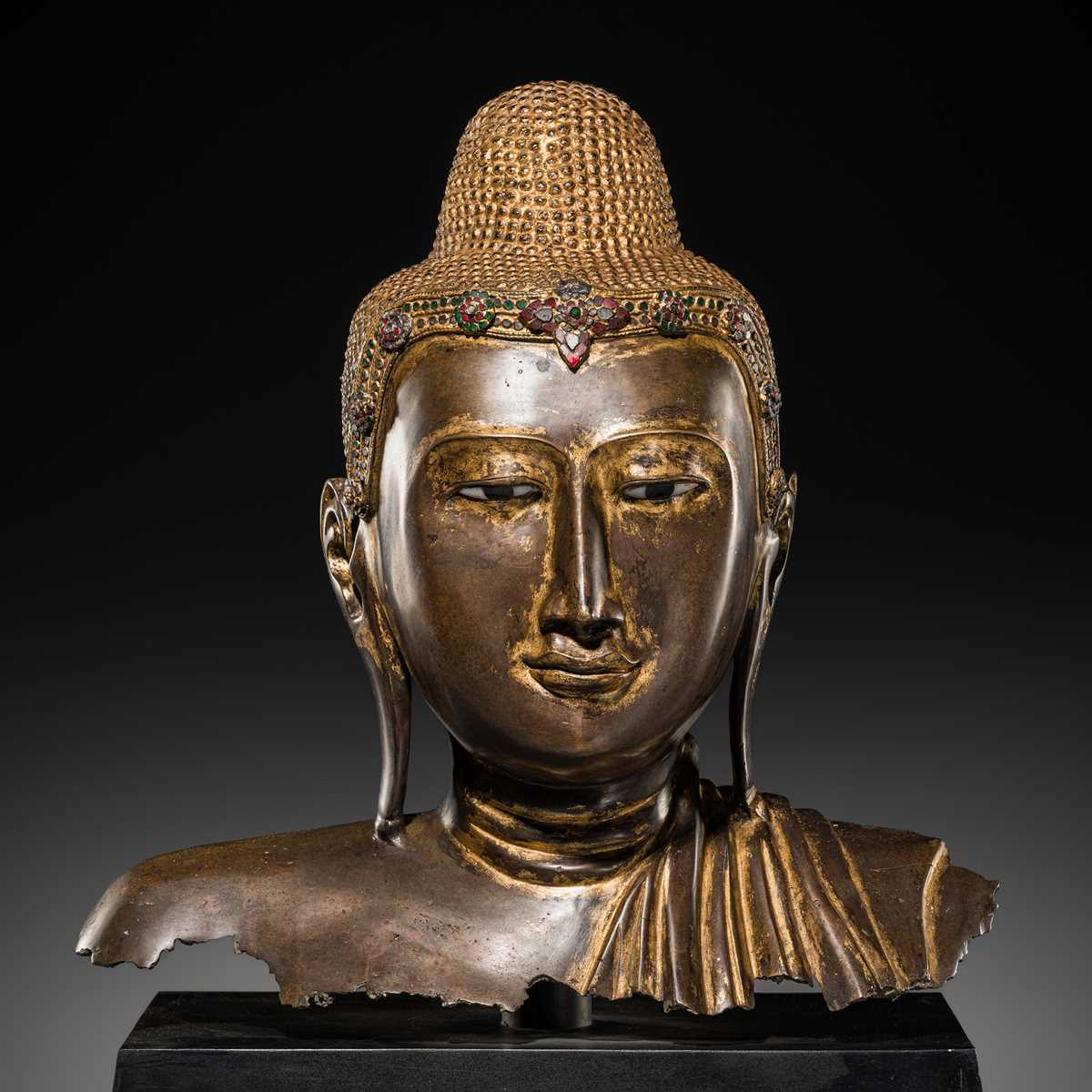 Lot 21 - A RARE AND LARGE GILT-LACQUERED BRONZE BUST OF BUDDHA, EARLY MANDALAY PERIOD