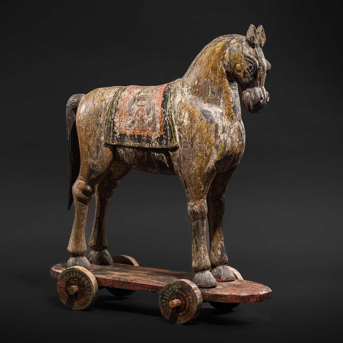Lot 101 - A RARE AND LARGE POLYCHROME WOOD PULL-TOY HORSE