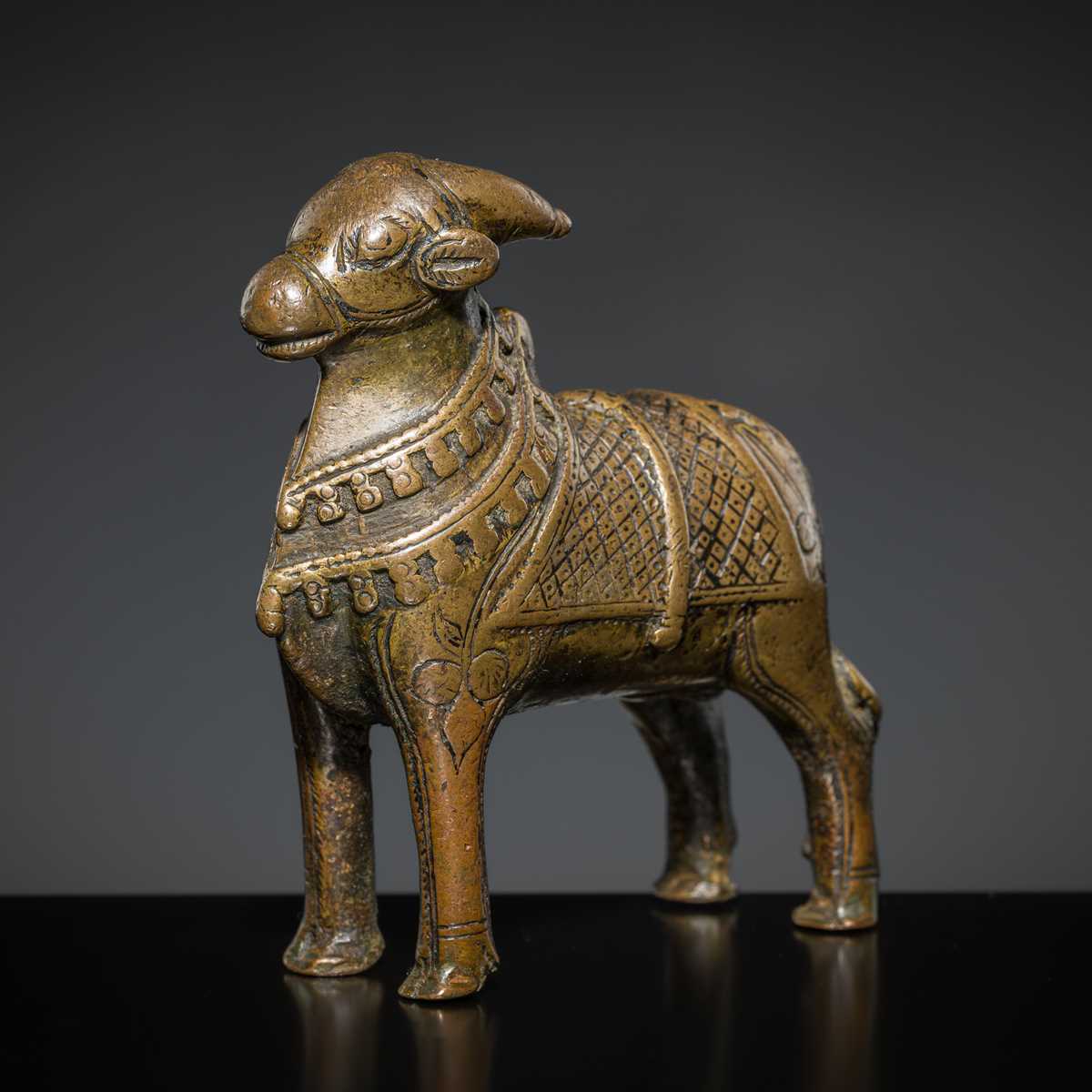 Lot 85 - A COPPER ALLOY FIGURE OF NANDI, NORTHERN INDIA, 18TH-19TH CENTURY