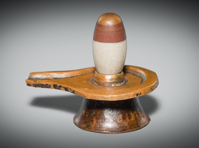 Lot 187 - A NARMADA RIVER STONE LINGAM AND COPPER YONI, 19TH CENTURY OR EARLIER