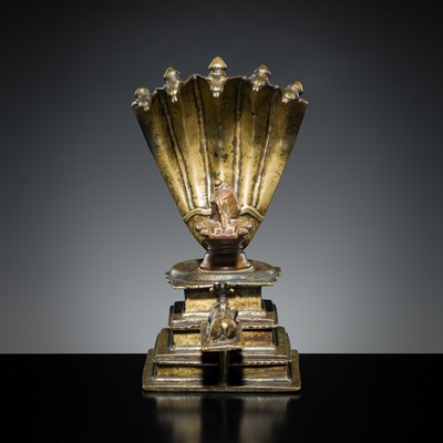 Lot 178 - A COPPER SHIVA MUKHALINGAM AND A BRONZE YONI WITH NANDI AND FIVE-HEADED NAGA CANOPY, MAHARASHTRA, 17TH AND 18TH CENTURY