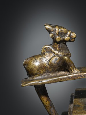 Lot 178 - A COPPER SHIVA MUKHALINGAM AND A BRONZE YONI WITH NANDI AND FIVE-HEADED NAGA CANOPY, MAHARASHTRA, 17TH AND 18TH CENTURY