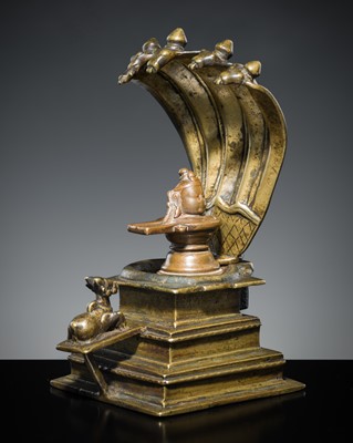 Lot 178 - A COPPER SHIVA MUKHALINGAM AND A BRONZE YONI WITH NANDI AND FIVE-HEADED NAGA CANOPY, MAHARASHTRA, 17TH AND 18TH CENTURY