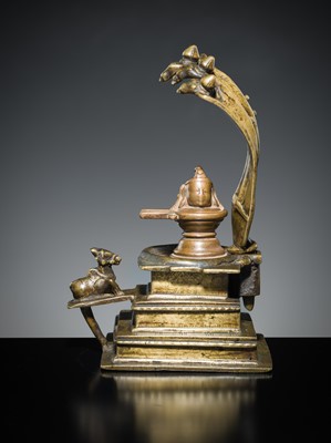 Lot 178 - A COPPER SHIVA MUKHALINGAM AND A BRONZE YONI WITH NANDI AND FIVE-HEADED NAGA CANOPY, MAHARASHTRA, 17TH AND 18TH CENTURY