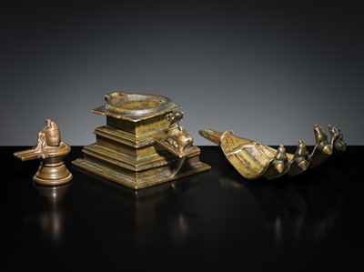 Lot 178 - A COPPER SHIVA MUKHALINGAM AND A BRONZE YONI WITH NANDI AND FIVE-HEADED NAGA CANOPY, MAHARASHTRA, 17TH AND 18TH CENTURY