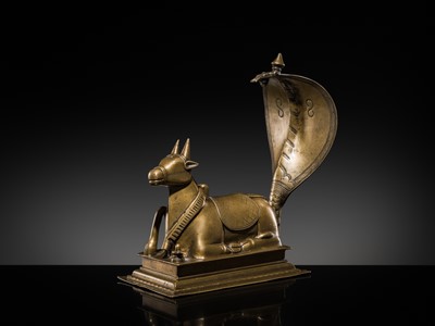 Lot 87 - A BRONZE FIGURE OF NANDI CANOPIED BY A NAGA, 18TH-19TH CENTURY