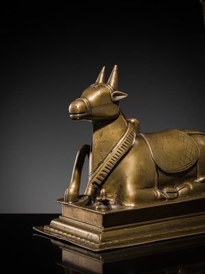 Lot 87 - A BRONZE FIGURE OF NANDI CANOPIED BY A NAGA, 18TH-19TH CENTURY