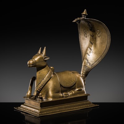 Lot 87 - A BRONZE FIGURE OF NANDI CANOPIED BY A NAGA, 18TH-19TH CENTURY