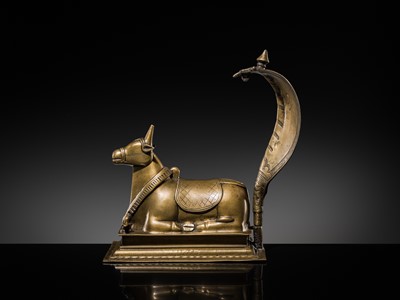 Lot 87 - A BRONZE FIGURE OF NANDI CANOPIED BY A NAGA, 18TH-19TH CENTURY