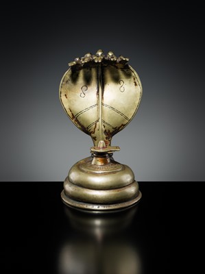 Lot 179 - A BRASS LINGAM WITH FIVE-HEADED NAGA CANOPY, MAHARASHTRA, 18TH-19TH CENTURY