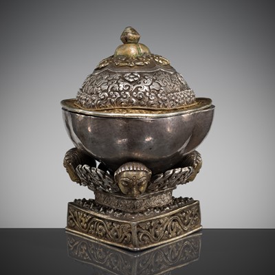 Lot 152 - A PARCEL-GILT SILVER REPOUSSÉ KAPALA AND STAND, TIBET, 18TH CENTURY