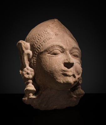 Lot 177 - A PINK SANDSTONE HEAD OF A GANDHARVA, WESTERN INDIA, CIRCA 16TH CENTURY