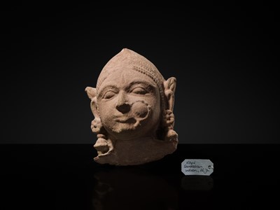 Lot 177 - A PINK SANDSTONE HEAD OF A GANDHARVA, WESTERN INDIA, CIRCA 16TH CENTURY