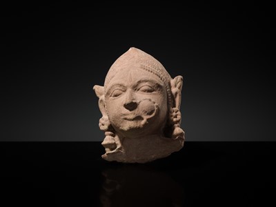 Lot 177 - A PINK SANDSTONE HEAD OF A GANDHARVA, WESTERN INDIA, CIRCA 16TH CENTURY