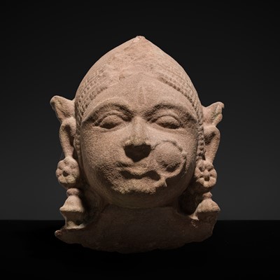 Lot 177 - A PINK SANDSTONE HEAD OF A GANDHARVA, WESTERN INDIA, CIRCA 16TH CENTURY