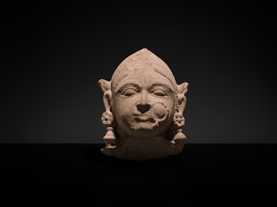 Lot 177 - A PINK SANDSTONE HEAD OF A GANDHARVA, WESTERN INDIA, CIRCA 16TH CENTURY
