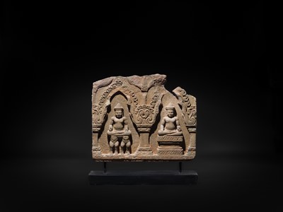 Lot 2 - A SANDSTONE RELIEF DEPICTING SURYA AND CHANDRA FROM THE NAVAGRAHA, ANGKOR PERIOD, 11TH-12TH CENTURY