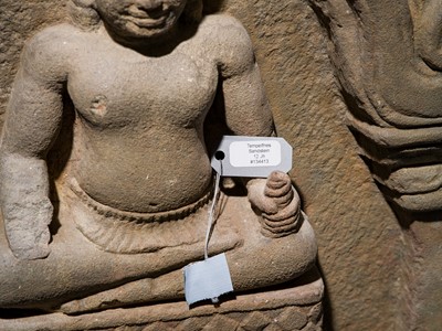 Lot 2 - A SANDSTONE RELIEF DEPICTING SURYA AND CHANDRA FROM THE NAVAGRAHA, ANGKOR PERIOD, 11TH-12TH CENTURY