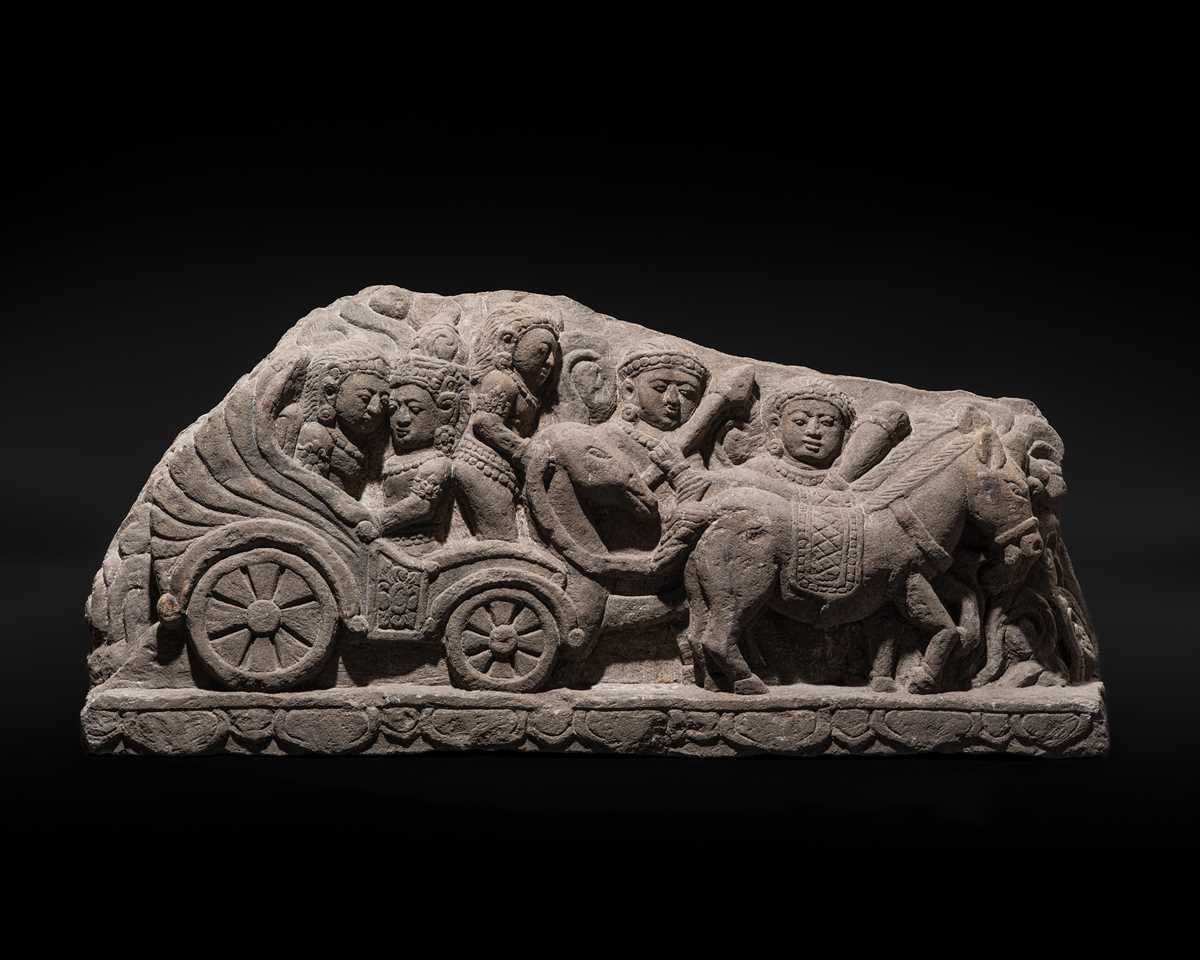 Lot 51 - A RARE ANDESITE RELIEF PANEL DEPICTING RAMA, SITA, AND LAKSHMANA LEAVING AYODHYA FOR EXILE, 9TH-13TH CENTURY