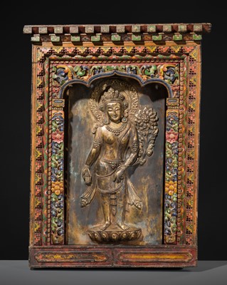 Lot 54 - A POLYCHROME WOOD SHRINE WITH A GILT-BRONZE REPOUSSÉ PLAQUE OF PADMAPANI LOKESHVARA, 18TH - 19TH CENTURY