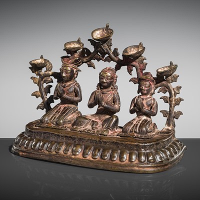 Lot 4 - A BRONZE RITUAL LAMP WITH ROYAL DONOR FIGURES, NEPAL, 19TH CENTURY