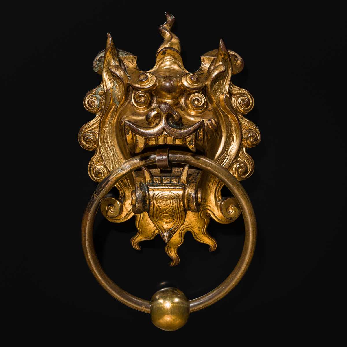 Lot 135 - A RARE GILT-BRONZE ‘BEAST-MASK’ DOOR KNOCKER, QING DYNASTY OR EARLIER