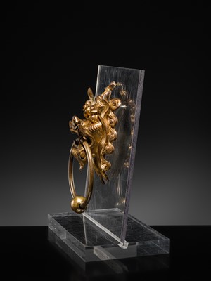 Lot 135 - A RARE GILT-BRONZE ‘BEAST-MASK’ DOOR KNOCKER, QING DYNASTY OR EARLIER