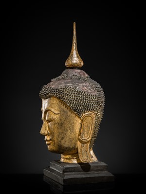 Lot 22 - A VERY LARGE GILT-LACQUERED WOOD HEAD OF BUDDHA, SHAN STYLE, 19TH CENTURY