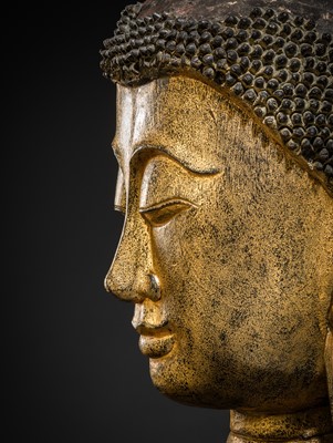 Lot 22 - A VERY LARGE GILT-LACQUERED WOOD HEAD OF BUDDHA, SHAN STYLE, 19TH CENTURY