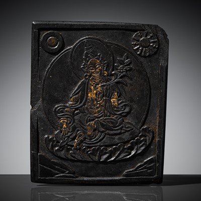 Lot 193 - A GILT-DECORATED BLACK STONE VOTIVE PLAQUE DEPICTING GREEN TARA, BHUTAN, 17TH-18TH CENTURY