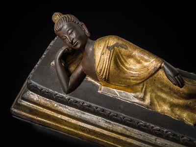 Lot 147 - A PARCE-GILT BRONZE FIGURE OF BUDDHA IN PARINIRVANA, RATTANAKOSIN KINGDOM