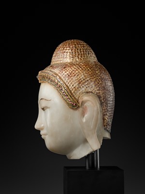 Lot 20 - A GILT-LACQUERED AND GLASS INLAID WHITE ALABASTER HEAD OF BUDDHA, MANDALAY, 18TH-19TH CENTURY